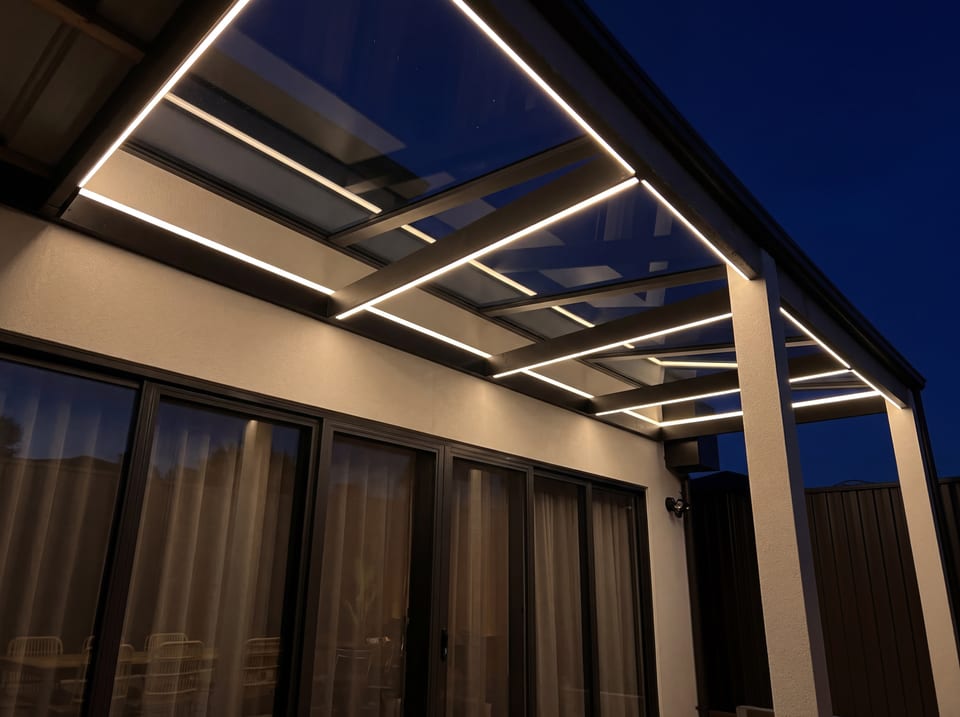 Outdoor patio lighting under a roof system at night