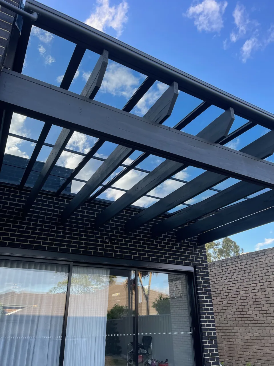 Underside view showing the retained pergola and new Clearview roof system