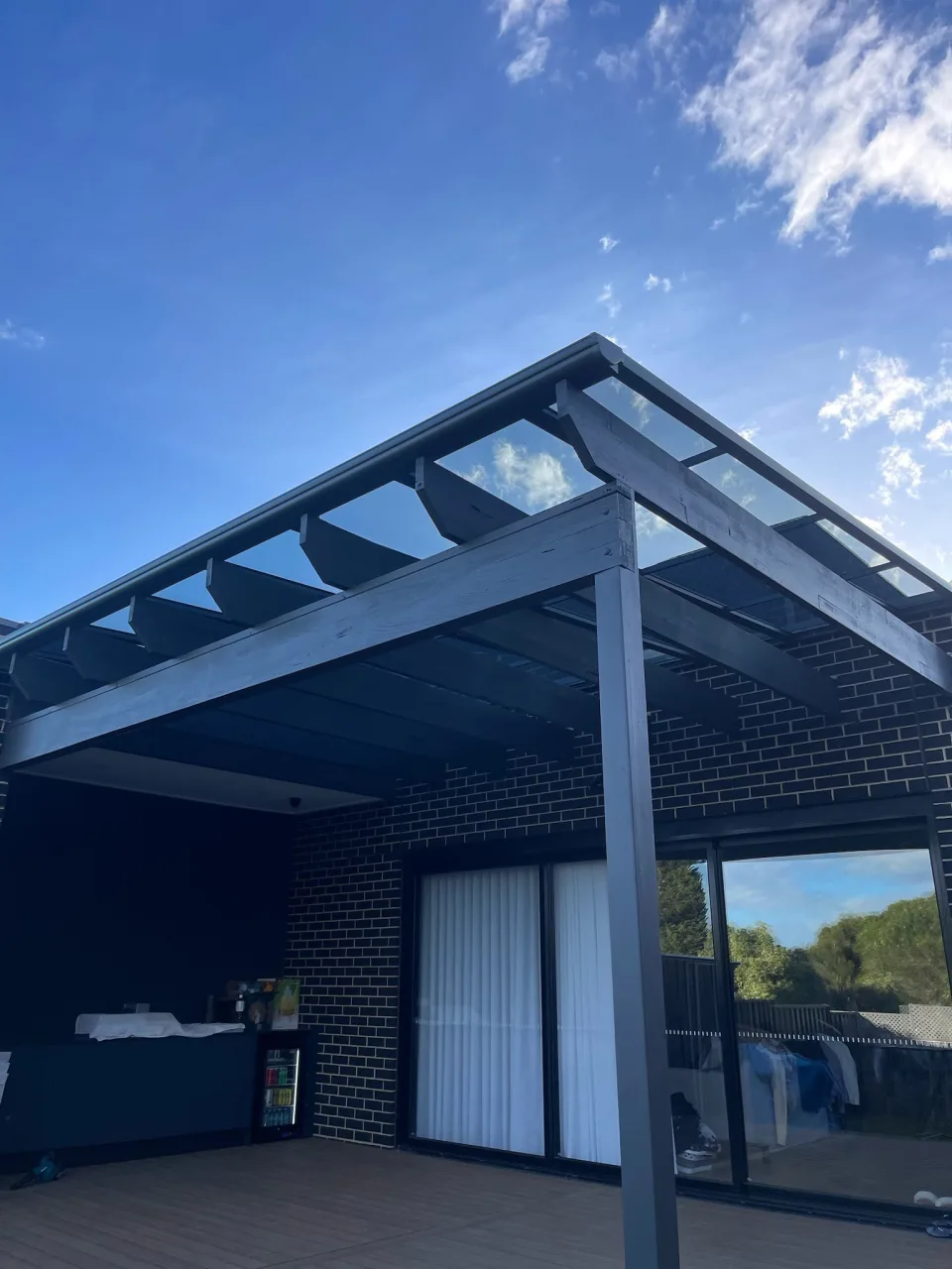 Completed transparent Clearview roof installed above a retained existing pergola