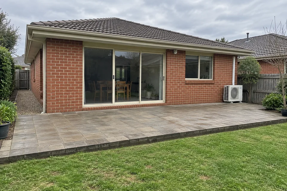 AI example: stand back to show the whole paved patio and house wall