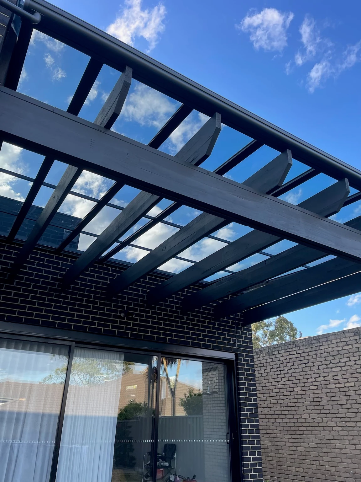 Full view of the retained pergola frame after Clearview transparent roofing and drainage were added